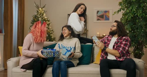 Friends Exchange Christmas Gifts in Cozy Living Room
