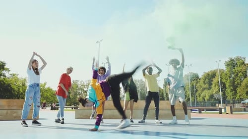 Teens Dancing and Celebrating with Smoke Flare in Park