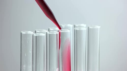 Close Up Chemist Pouring Red Liquid in Test Tube