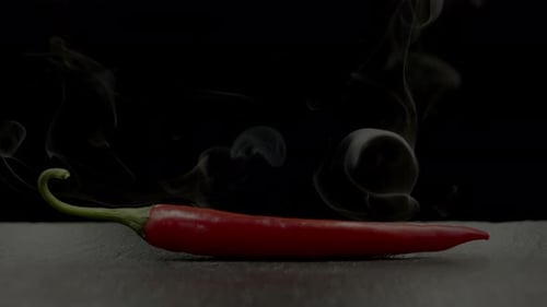 Red Chili Pepper with Smoke on Dark Background