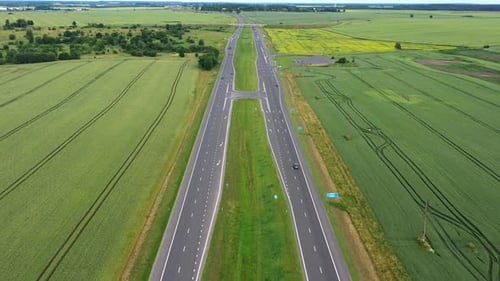 Asphalt Highway Through Green Summer Field