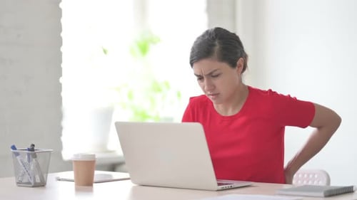 Indian Woman Having Back Pain While Using Laptop in Office