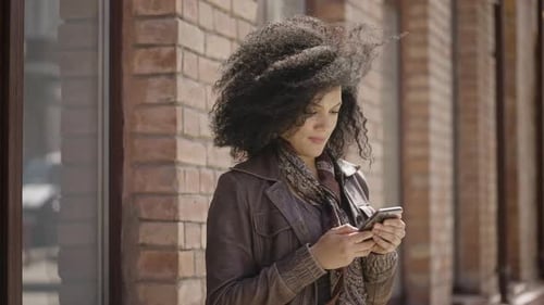 Woman Using Mobile Phone in Urban Setting
