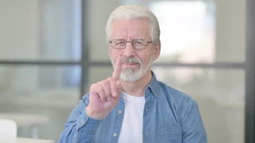 Portrait of Senior Old Doctor Showing No Sign By Finger
