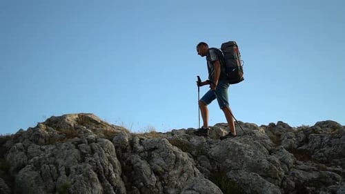Man Climbing Rock with Trekking Poles Spbd