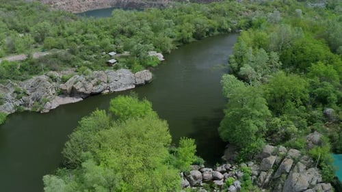 Aerial View of a River Flowing Past a Lake Separated By a Forest