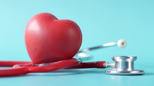 Red Heart With Stethoscope on Light Blue Surface