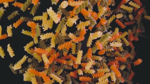 Colorful Rotini Pasta Falling in Close Up Shot