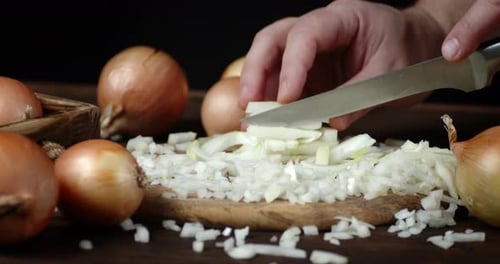 Male Hand Put Onion and Slice It on a Cutting Board.
