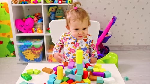 Adorable Child Plays with Colorful Building Blocks