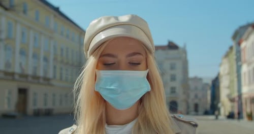 Young Woman Wearing a Face Mask in City