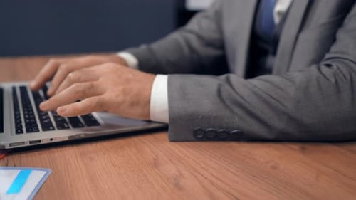 People at Work Typing on Laptop and Writing