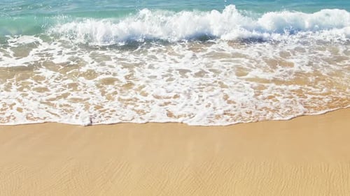 Slow Motion View of Ocean Blue Waves Breaking Splashing on Golden Sandy Beach