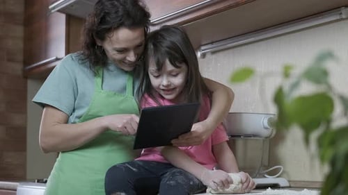 Woman and Child Baking at Home Together