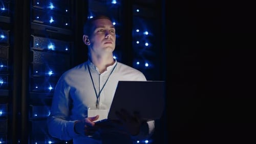 Young Adult Man Working With Laptop in Data Center