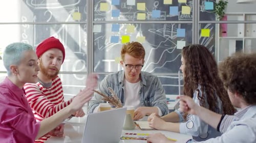 Team Brainstorming Together in Modern Office