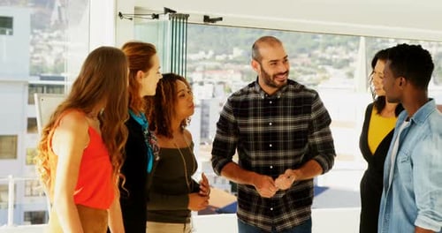 Team of executives interacting with each other while working in the office