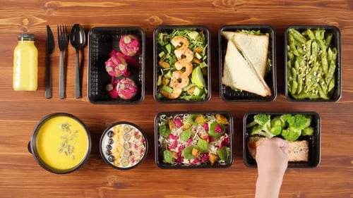 Food Delivery Top View Take Away Meals in Disposable Containers on Wooden Table