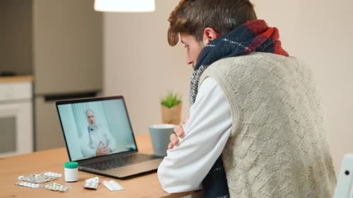 Man Talking With Doctor During Online Consultation