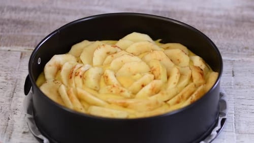 Arranging Sliced Apples in Pie Crust for Baking
