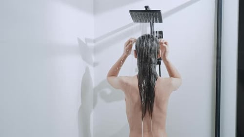 Woman Washing Long Dark Hair in Shower