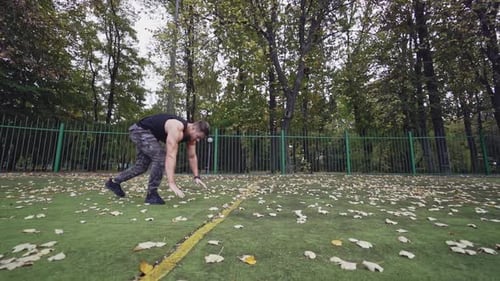 Muscular Man Doing Push Ups and Squat Jumps