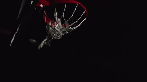 Men Play Basketball Under Bright Light At Night