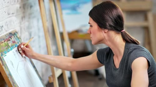 Woman Painting Artwork on Canvas in Art Studio