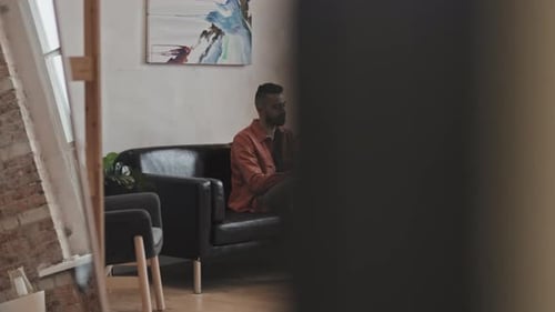 Man Using Laptop Relaxing at Home