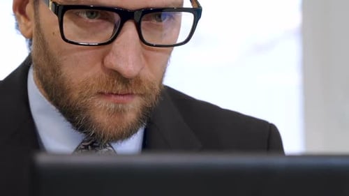 Businessman Works on Laptop