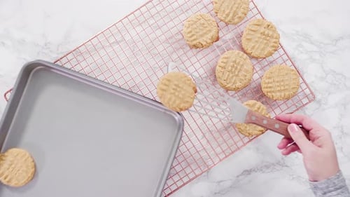 Flat lay. Step by step. Freshly baked peanut butter cookies on baking sheet.