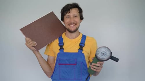 Man Smiling Holding Angle Grinder and Tile