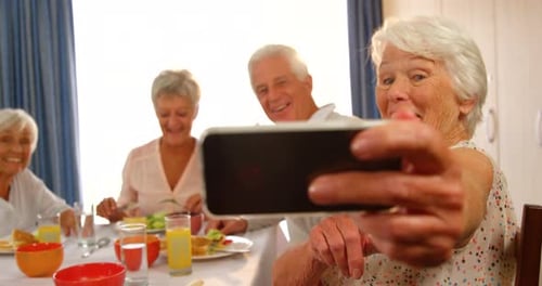 Seniors Taking Selfie at Meal Together