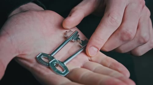 Hand Shows Two Keys