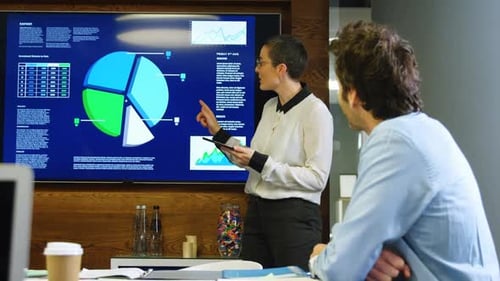 Woman Presents Data in Modern Office