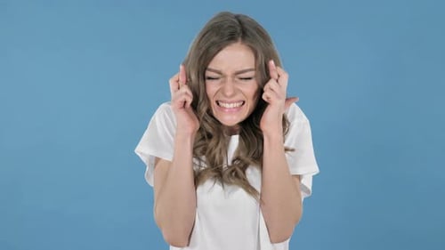 Young Woman Crossing Fingers Making Wishing Gesture