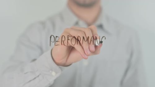 Man Writes the Word Performance With a Marker