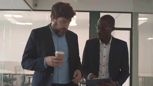 Two Businessmen Going along Office and Talking
