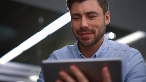 Smiling Man Using Tablet for Video Call