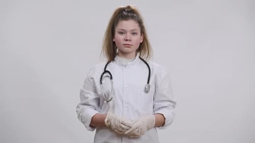 Teen Doctor Gives Thumbs Up in Lab Coat
