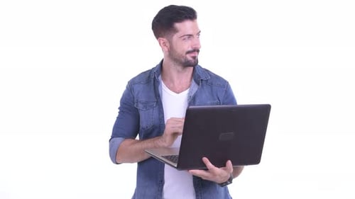 Man Types on Laptop, Looks Up and Thinks