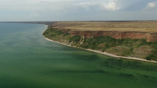 Drone Footage of the Shoreline of the Sea with Steep Hills, Nature