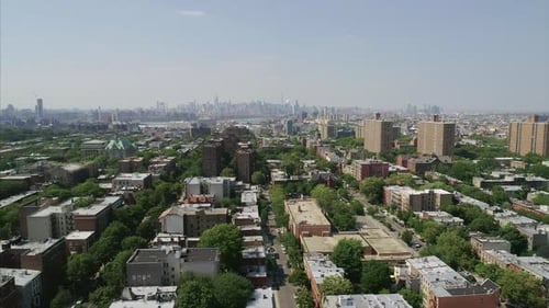 Aerial Long Shot of Brooklyn neighborhood with NYC Manhattan Skyline