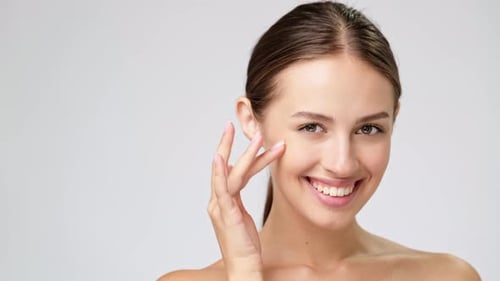 Close up of Smiling Woman Touching Her Face