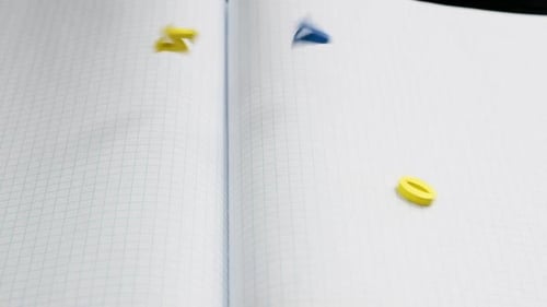 Colorful Alphabet Letters Falling onto Open Notebook