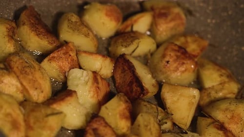 Golden Roasted Potatoes Sizzle in a Pan