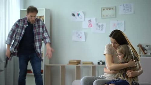 Scared Mother and Child Facing Angry Man