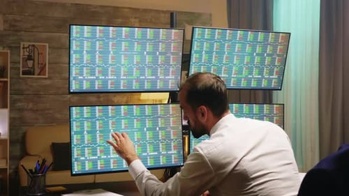 Broker Working From Home Office at Night