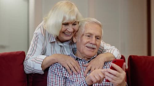 Affectionate Senior Couple Enjoying a Mobile Phone Together