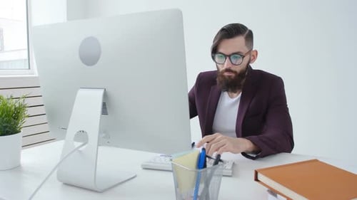 Concept of Freelancing and Work Office. Young Stylish Employee Looking at Computer Monitor